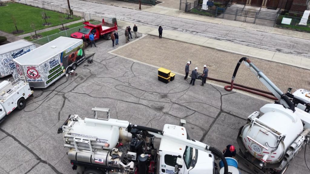 Aerial view of vacuum truck fleet servicing permeable pavement site